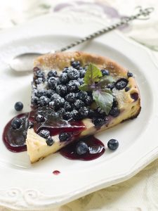 Slice of cake with blueberries, selective focus